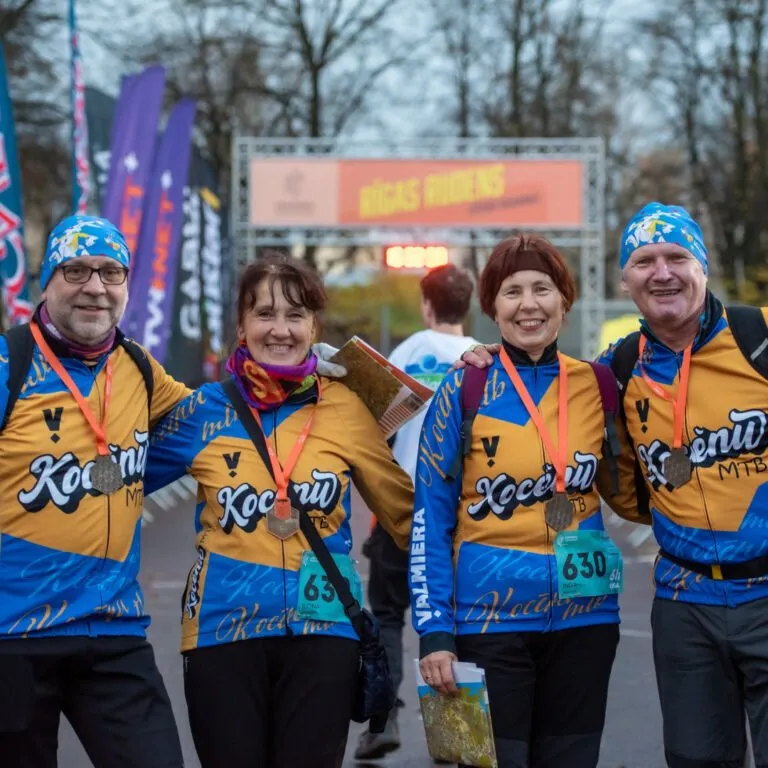 Rogaining participants with maps and medals after the finish