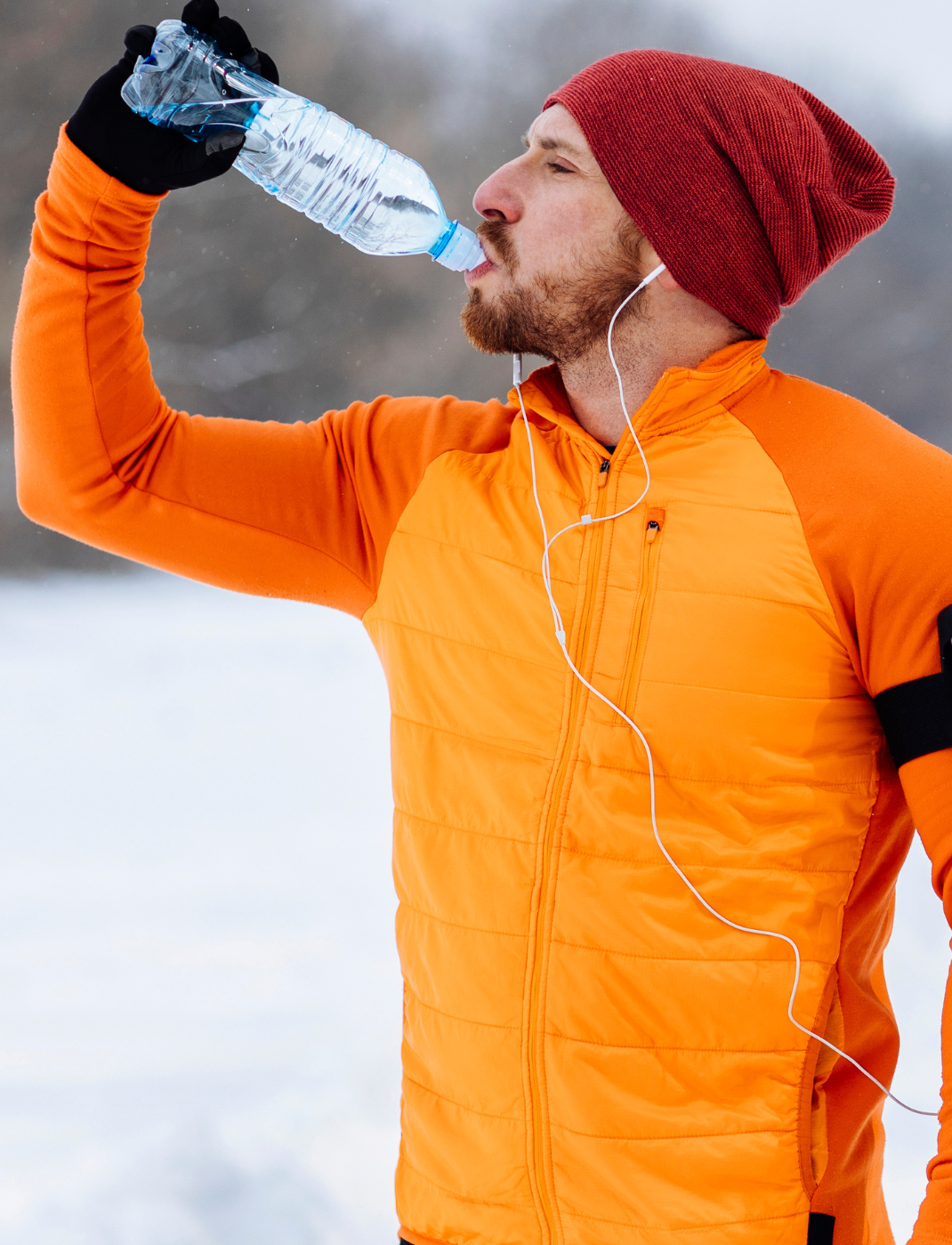 Athlete drinking water during winter training
