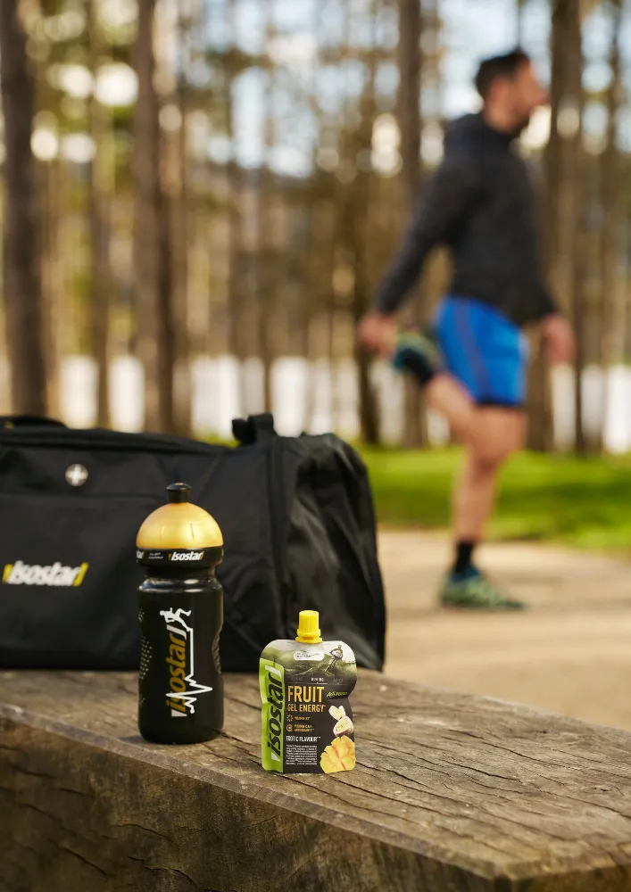 Isostar bottle and energy product beside a training route