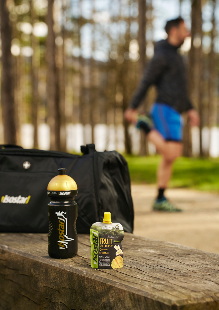 Isostar bottle and energy product beside a training route