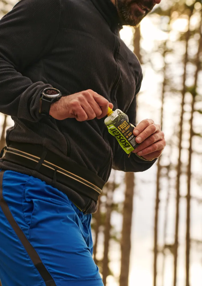 Athlete using an Isostar energy product during training